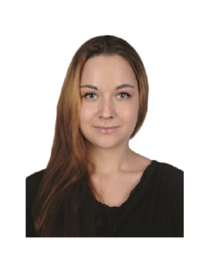 Portrait of a woman with long brown hair wearing a black top, facing the camera against a white background.
